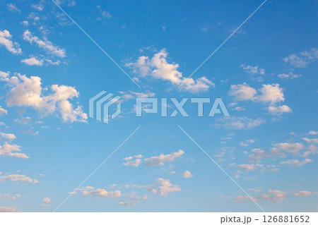blue sky with clouds on a sunny august morning. fluffy formations in bright weather. blue nature backdrop in morning light. warm forecast background during summer 126881652