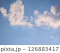 Vast blue sky with fluffy white clouds on a bright day 126883417