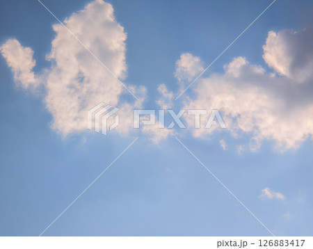 Vast blue sky with fluffy white clouds on a bright day Vast blue sky with fluffy white clouds on a bright day 126883417