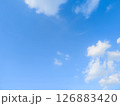 Vast blue sky with fluffy white clouds on a bright day 126883420