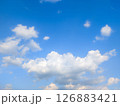 Vast blue sky with fluffy white clouds on a bright day 126883421