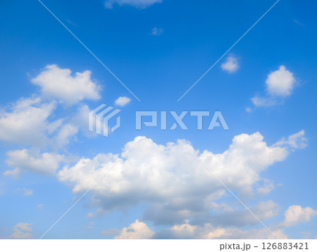 Vast blue sky with fluffy white clouds on a bright day 126883421