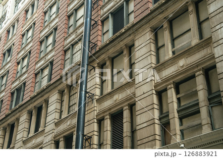 Close-up of a stone and brick building showing architectural details. The historic style reflects New York's urban heritage. Close-up of a stone and brick building showing architectural details. The historic style reflects New York's urban heritage. 126883921