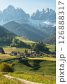 Visit Italy. Morning light spills over Santa Maddalena quaint village and sharp Dolomite peaks, a vertical frame of alpine calm and storybook charm 126888317