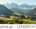 Visit Italy. Framed by towering peaks, the quiet village of Santa Maddalena glows at sunrise, a serene start to the day in the dramatic Dolomites 126888319