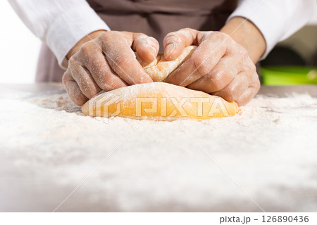 Baking concept. Caucasian female hands kneading the dough. Baking concept. Caucasian female hands kneading the dough. 126890436