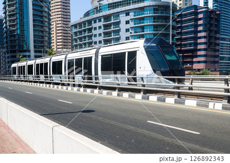 Futuristic Driverless Tram Gliding Through the City Streets - A Vision of Modern Urban Transport Futuristic Driverless Tram Gliding Through the City Streets - A Vision of Modern Urban Transport 126892343