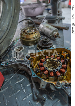 Motorcycle stator repairing in mechanical workshop 126892980