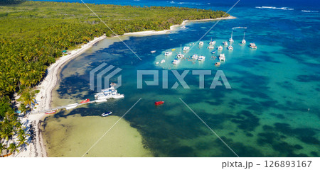 Boats with people having fun in caribbean sea near tropical island with palm trees. Travel destination. Aerial view Boats with people having fun in caribbean sea near tropical island with palm trees. Travel destination. Aerial view 126893167