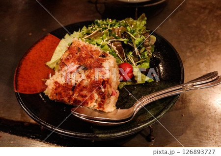 close up of a smashed tomato salad as cold cut appetiser in a black bowl 126893727