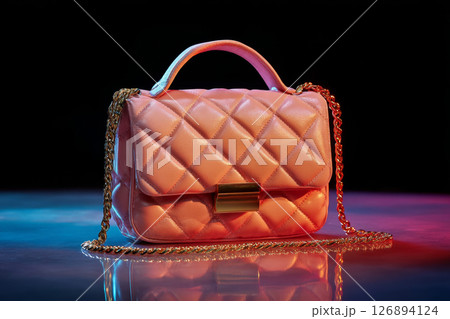 Your It Bag pink quilted handbag with gold hardware and chain strap illuminated with soft colored lights 126894124