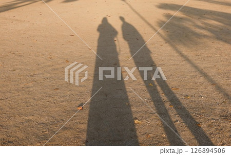 two shadow of a lady and a man on the sandy ground with copy space two shadow of a lady and a man on the sandy ground with copy space 126894506