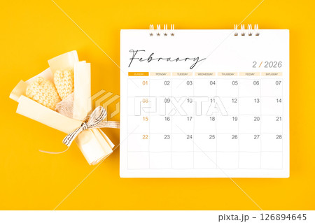 2026 February desk calendar and Yellow bouquet on yellow background. 126894645