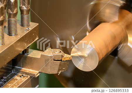 Closeup scene the lathe machine rough cut the metal parts by coating tool. 126895333