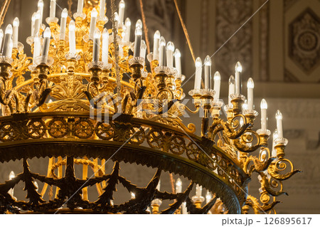 Detailed view of a luxurious golden chandelier 126895617