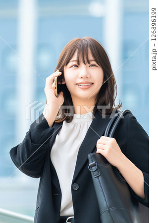 スマートフォンで話す笑顔の女性・ビジネスウーマン スマートフォンで話す笑顔の女性・ビジネスウーマン 126896199