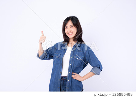 Southeast Asian woman in casual denim shirt smiling and showing thumbs up gesture with confidence and positivity on white background 126896499