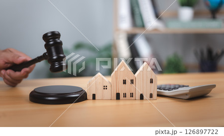 Gavel, houses, calculator. Symbolizes real estate law, property auctions, legal decisions, financial valuation. Ideal for housing market, mortgage, investment concept. Represent legal judgment finance 126897722
