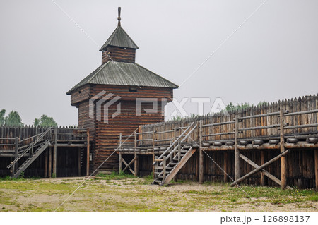 Ancient russian fortress with high wooden tower and palisade, evoking historical battles and medieval life Ancient russian fortress with high wooden tower and palisade, evoking historical battles and medieval life 126898137