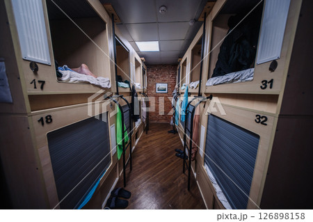 Compact sleeping pods inside a modern hostel providing comfortable accommodation for travelers 126898158