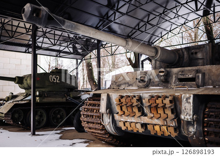 German Tiger I and Soviet T-34-85 tanks standing in museum hangar 126898193