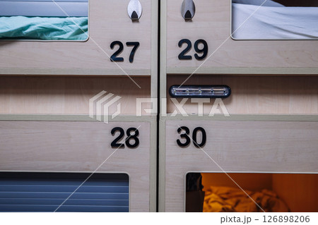 Modern capsule hotel offering comfortable and private sleeping pods 126898206