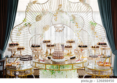 Delicious macarons and pastries decorating a luxurious candy bar buffet 126898450