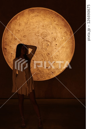 An Enigmatic Silhouette Set Against the Beautiful Radiance of a Full Moon at Night Time 126898675