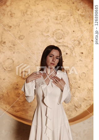 An Elegant Woman in a Stunning White Dress Posing Against a Beautiful Moon Background 126898685