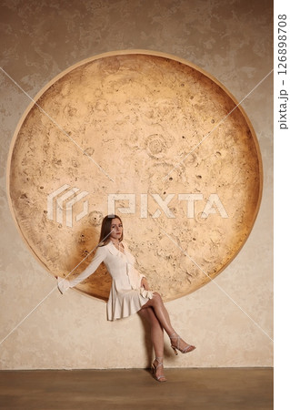 An Elegant Pose Set Against a Stylish Circular Structure in Artistic Presentation An Elegant Pose Set Against a Stylish Circular Structure in Artistic Presentation 126898708
