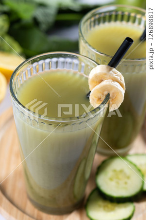 Green smoothie with spinach,banana, apple, and lemon on white marble Green smoothie with spinach,banana, apple, and lemon on white marble 126898817