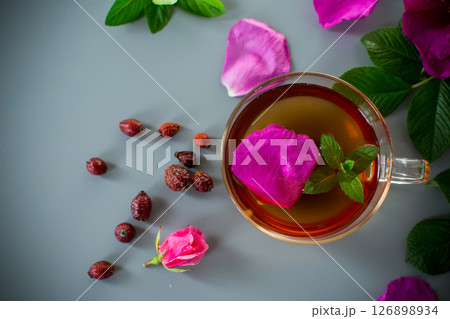 Aesthetic serving of tea with rosehip, petals and mint greens 126898934