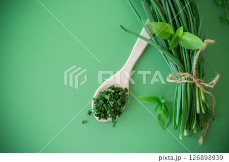Dried and fresh green onions on green background from above Dried and fresh green onions on green background from above 126898939