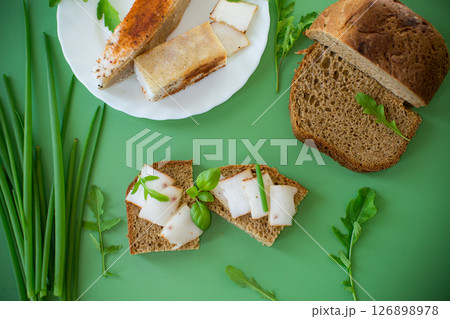 Traditional Ukrainian dish with lard and greens on a green background 126898978
