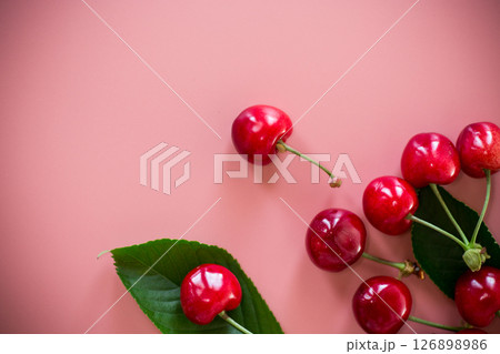 Ripe red cherries on pink background from above 126898986