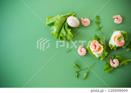Appetizing breakfast with shrimp, egg and greens on top Appetizing breakfast with shrimp, egg and greens on top 126899004