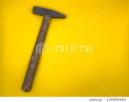 Rusty old hammer with wooden handle on yellow background. Flat lay. Top view, copy space. 126900460