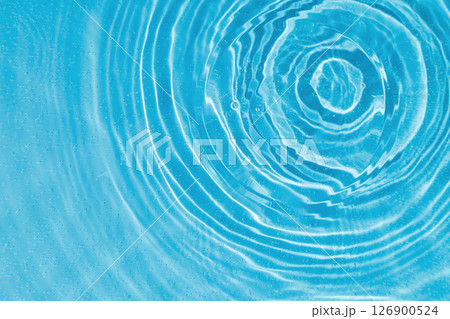 drops on water with circles on a blue background drops on water with circles on a blue background 126900524
