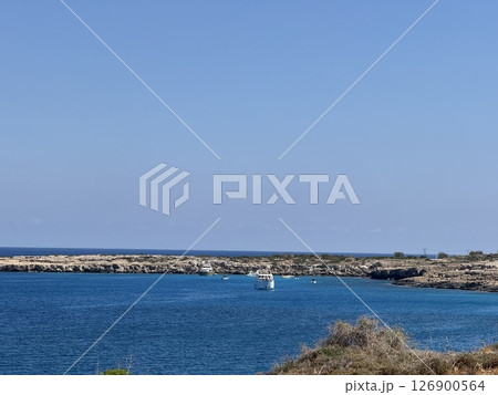 Picturesque beach, waves crashing on the sandy shore. Sea waves beat against the rocks. Cyprus Island, Mediterranean Sea. 126900564