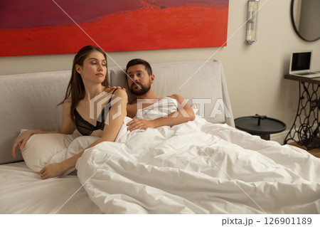 Loving couple relaxing and lying down in bed Loving couple relaxing and lying down in bed 126901189