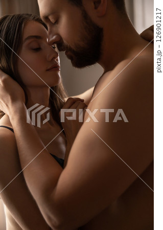 Woman cuddling her attractive partner in house lovers touching tenderly Woman cuddling her attractive partner in house lovers touching tenderly 126901217