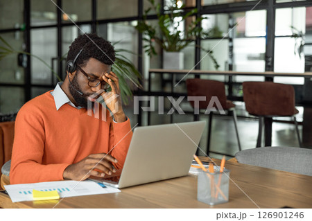 African american entrepreneur looking tired after hours of overtime African american entrepreneur looking tired after hours of overtime 126901246