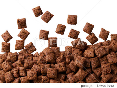chocolate corn pads scattered in a white background, top view. 126901548