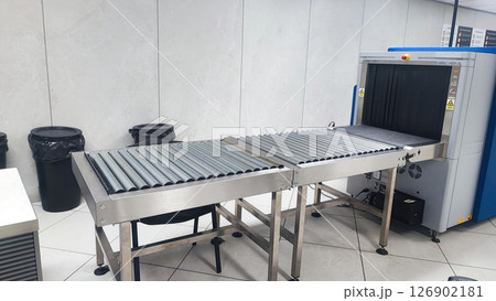 Security Checkpoint in Airport Terminal: Suitcases and Bags of Passengers Moving on Conveyor Belt Inside Advanced Metal Detector X-ray Scanner. Baggage Screening Procedure for Boarding Plane Flight. 126902181