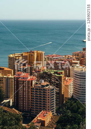 Coastal cityscape with vibrant buildings overlooking the serene sea. Coastal cityscape with vibrant buildings overlooking the serene sea. 126902538