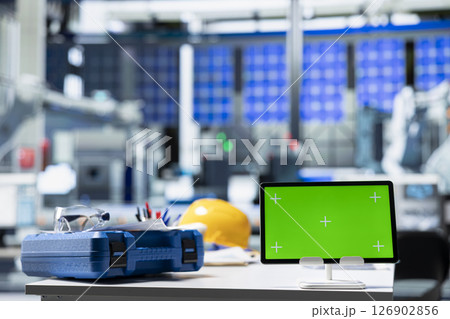 Chroma key display on PC in photovoltaics factory used to oversee production line, analyzing data and reviewing system metrics. Computer in solar panels plant, work on renewable energy. Chroma key display on PC in photovoltaics factory used to oversee production line, analyzing data and reviewing system metrics. Computer in solar panels plant, work on renewable energy. 126902856