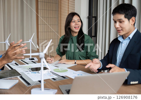 ESG Strategy Meeting. Professionals discussing renewable energy solutions with wind turbines. 126908176