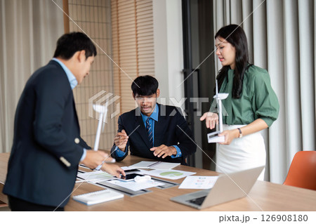 ESG Initiative Discussion. Professionals strategizing on sustainable practices in a modern workspace. ESG Initiative Discussion. Professionals strategizing on sustainable practices in a modern workspace. 126908180