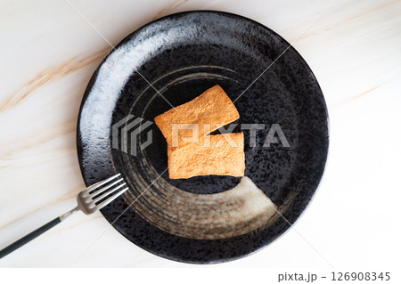 黒皿に映える焼き菓子二個⑦ 126908345