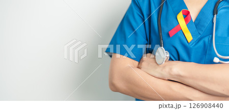 World hepatitis day awareness month, 28 July. Doctor holding Red and Yellow ribbon. Liver cancer, Jaundice, Cirrhosis, Failure, Enlarged, Hepatic Encephalopathy and Health concept 126908440